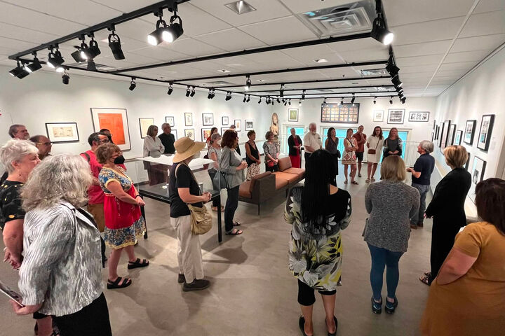 A group listens to a docent at the Dr. Caroline Beebe Gallery on the IU Bloomington campus.